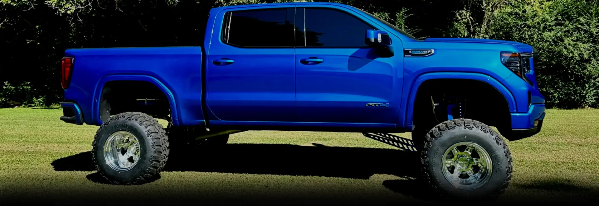Lifted blue GMC truck built by Shifted Industries